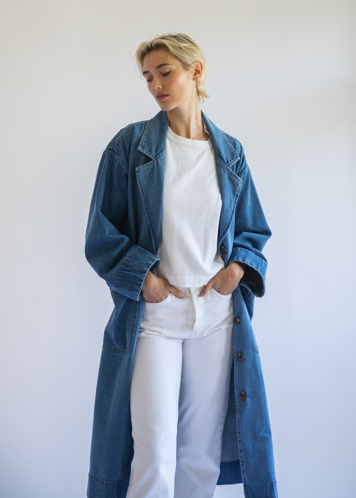 Organic denim jacket on model with white background. Medium blue denim. Relaxed oversized fit.