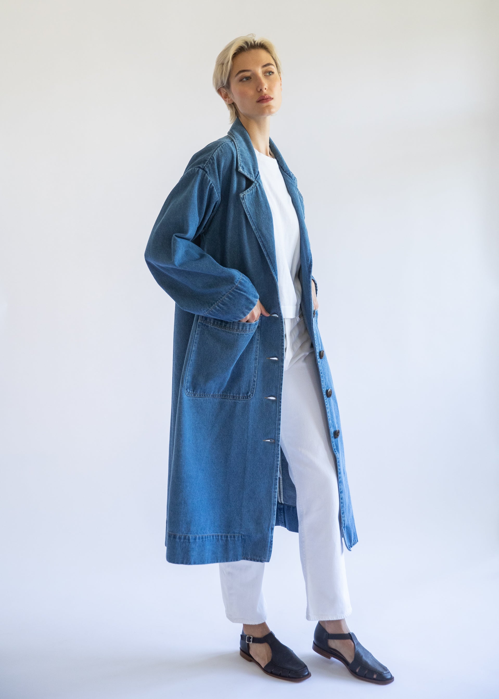 Organic denim jacket on model with white background. Medium blue denim. Relaxed oversized fit. 